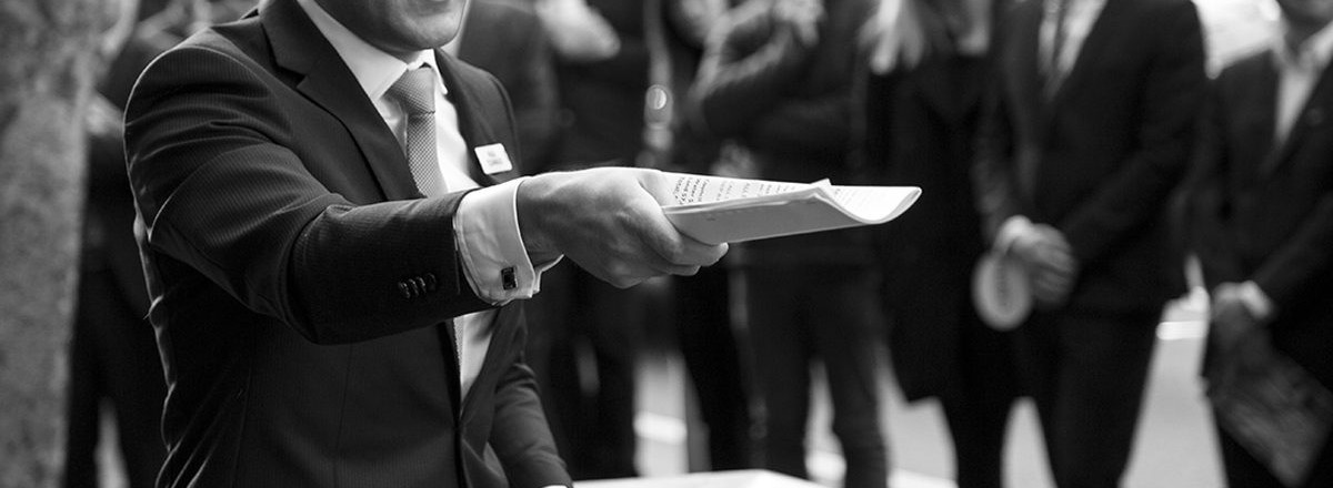 The Auction Company auctioneer calling an auction in front of a crowd